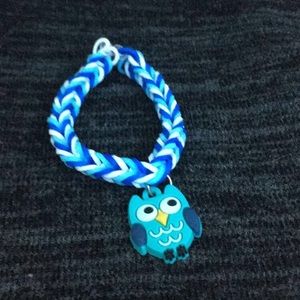 A blue and white bracelet with a owl charm